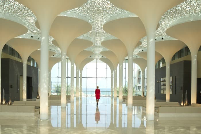 Woman walks through the lobby at the Kempinski Hotel in Oman