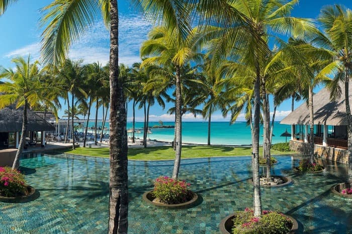 Outdoor pool and cabanas at Belle Mare Plage in Mauritius