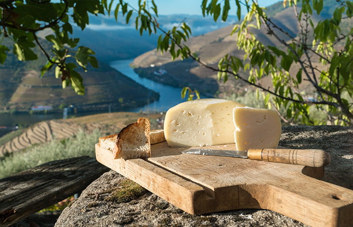 Traditional Portuguese Cheese on Wooden Board overlooking the Duoro Valley, Portugal