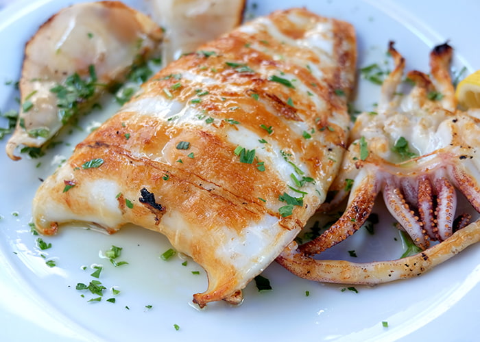 Grilled calamari dish served at restaurant in Santorini, Greece