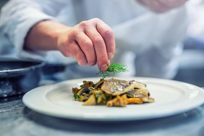 Chef putting finishing touches on dish