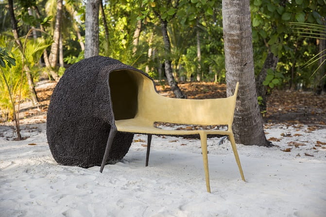 Art installation of a chair on the beach.