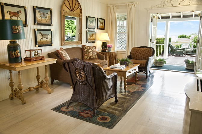 A living room area with hanging pictures on the walls at The Wauwinet inn.