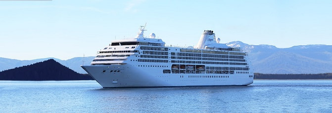 Exterior view of a Regent Seven Seas cruise ship at sea.