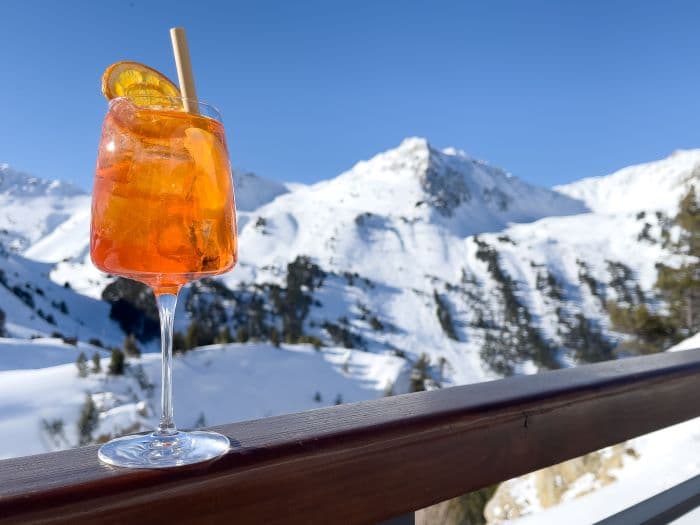 Aperol Spritz cocktail mountain background