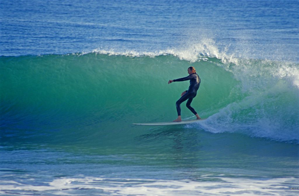 Surfer riding wave in California